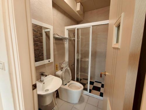 a small bathroom with a toilet and a sink at 晨星慢旅 Morning Star in Jian