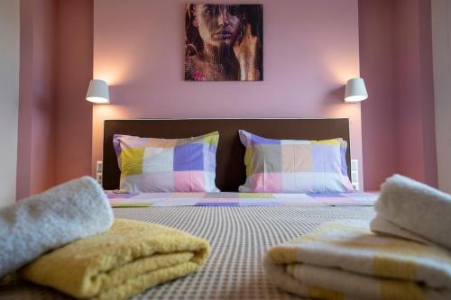 a bedroom with a bed with towels on it at Palm Tree Beach Villa in Kakongiónion