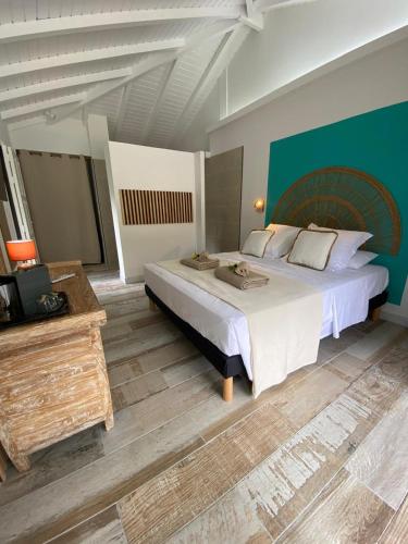 a large bedroom with a large bed and a television at Résidences de la Métisse in Saint-François