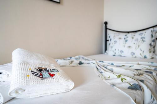 a bed with a pillow with a dog on it at Palm Tree Beach Villa in Kakongiónion