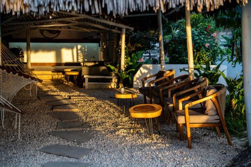 a group of chairs sitting under an umbrella at ZAN Beach House in Bwejuu