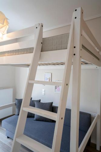 a bunk bed with a ladder in a room at Palm Tree Beach Villa in Kakongiónion