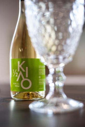 a bottle of wine sitting next to a wine glass at Palm Tree Beach Villa in Kakongiónion