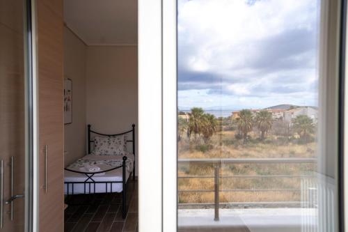 a room with a window with a bed and a view at Palm Tree Beach Villa in Kakongiónion