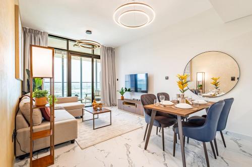a dining room and living room with a table and chairs at Full Cleveland & Canal View - 5 min walk from Cleveland, ADGM and Galleria - Big Balcony - High Floor in Abu Dhabi