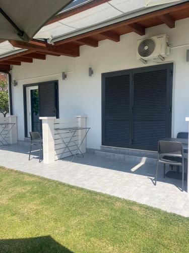 a patio with black blinds on the side of a house at Alma Suite Bed and Breakfast in Nettuno