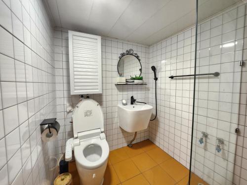 a bathroom with a toilet and a sink and a mirror at Mook Seoul in Seoul