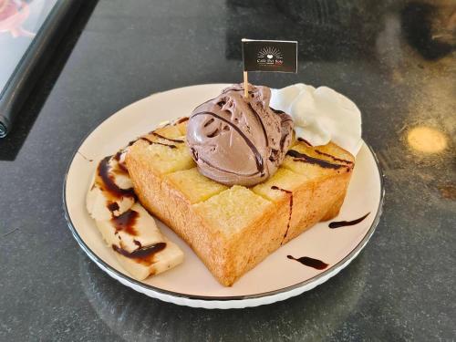 a plate with a piece of cake with chocolate ice cream at Mantra Beach Condominium Suite - Mae Phim in Ban Tha Fat