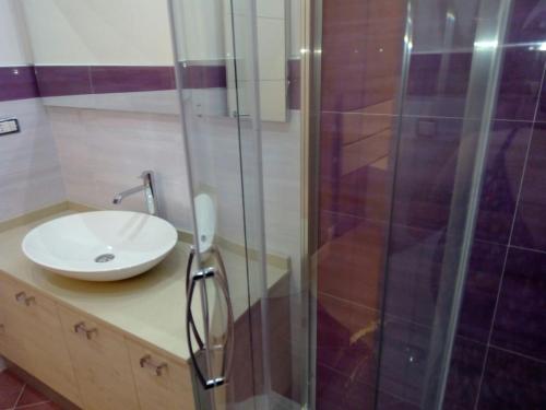 a bathroom with a sink and a shower at Luxury B&B Coccolhouse in San Cesario di Lecce