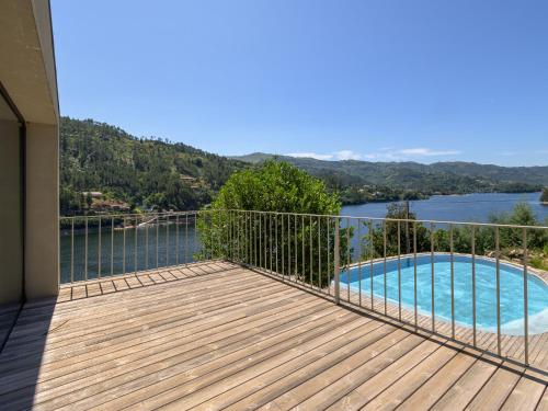 a balcony with a view of a swimming pool at Casa do Gerês 2021 in Geres