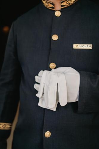 a man in a black shirt and white gloves at Kenzi Basma in Casablanca