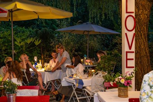 a group of people sitting at tables in a restaurant at Villa Valentina in Levanto