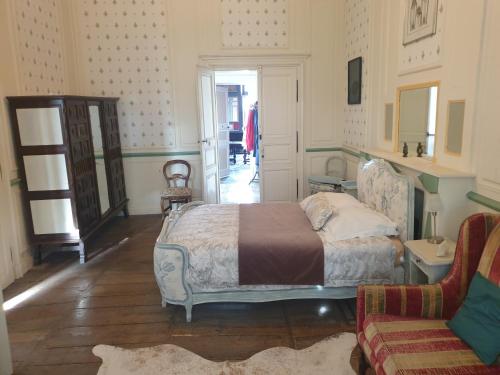 a bedroom with a bed and a couch in it at Le Chateau in Châteauponsac