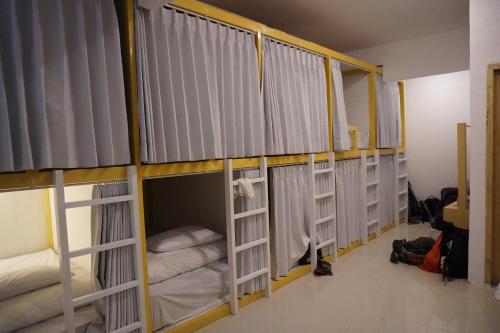 a row of bunk beds in a room at Dream CoWork Hotel in Kuta Lombok