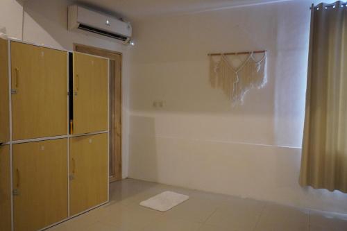 an empty room with a closet and a curtain at Dream CoWork Hotel in Kuta Lombok