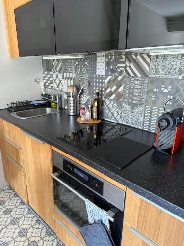 a kitchen with a black counter top with a dishwasher at Verbier Apt 2 rooms in Verbier