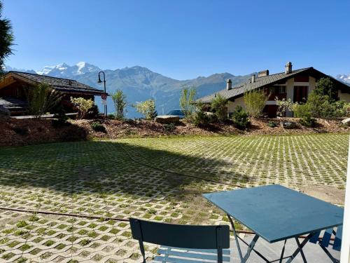 a table and chairs in a yard with a house at Verbier Apt 2 rooms in Verbier