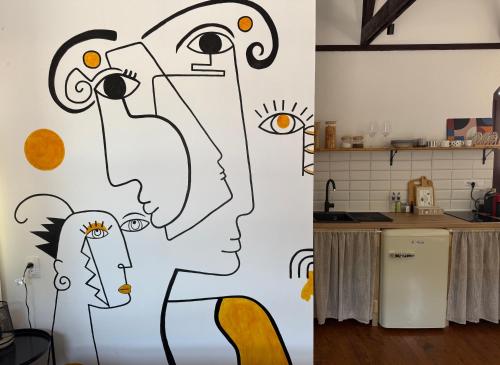 a kitchen with a mural of two people at Atelje 1981 Apartment in Bijelo Polje