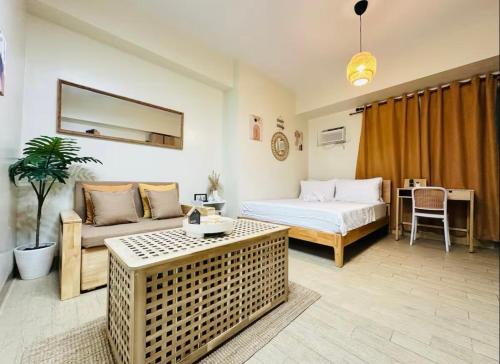 a hotel room with a bed and a couch at Skyline Stay in Manhattan in Manila