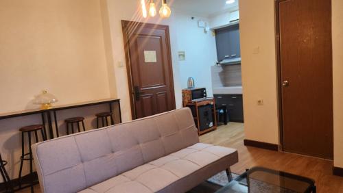 a living room with a couch and a table at Majesty Apartemen Strategis Dekat Mall Toll Dan segalanya in Bandung