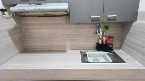a kitchen with a sink in the floor at Majesty Apartemen Strategis Dekat Mall Toll Dan segalanya in Bandung