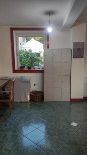 a room with a bed and a window in it at Woodpecker Backpacker Hostel in Herceg-Novi