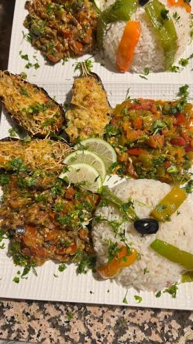 a plate of food with rice and meat and vegetables at La Sultana Luxury Camp in Merzouga