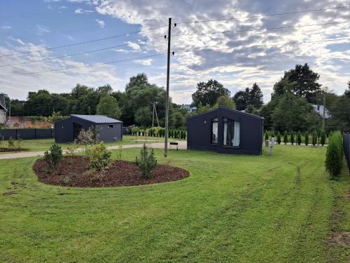 a tiny house in the middle of a yard at Sun coast house in Saulkrasti