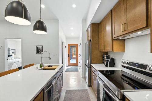 a kitchen with white counter tops and wooden cabinets at 500 House - Unit B townhouse in Thiensville