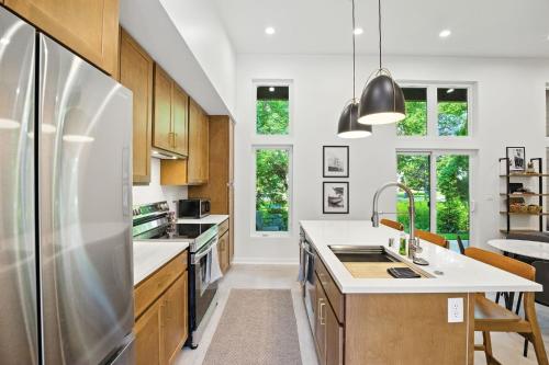 a kitchen with wooden cabinets and a stainless steel refrigerator at 500 House - Unit B townhouse in Thiensville