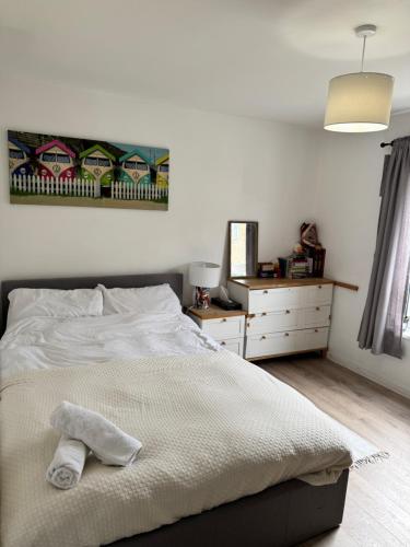 a bedroom with a bed and a dresser and a mirror at Sunset View 2BR Apartment - Beautiful London View & Free Parking in London