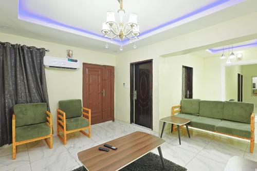 a living room with a couch and two chairs at Victoria Flats in Ijegun