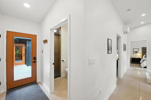 a hallway with white walls and a brown door at 500 House - Unit D townhouse in Thiensville