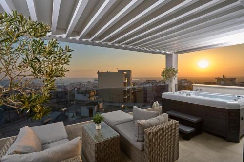 a living room with a hot tub on top of a building at SIGMA Suites Hotel in Thessaloniki