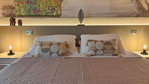 a bedroom with a large bed with pillows at Giardino Giusti House & Court in Verona