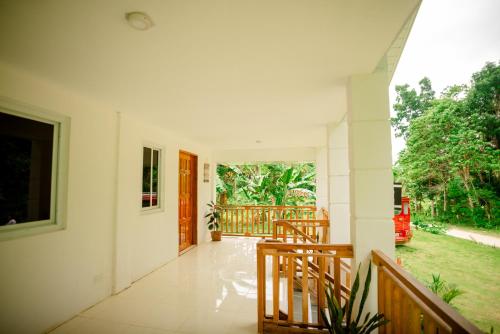 a hallway of a house with a porch and a door at Loboc Nature View House in Loboc