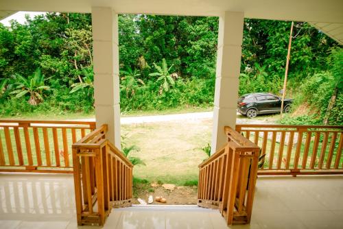 a porch with a view of a car at Loboc Nature View House in Loboc