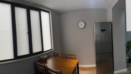 a kitchen with a wooden table and a refrigerator at Sunny Escape in Gonio in Gonio