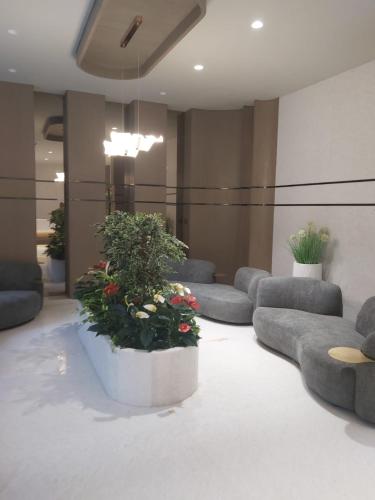 a lobby with couches and plants in a room at Neon - Royal Nest Aerotel with Pvt Balcony -1 km from Airport in Pune