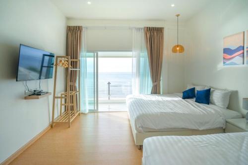 Ένα ή περισσότερα κρεβάτια σε δωμάτιο στο Bubble Sea Beachfront Chaam