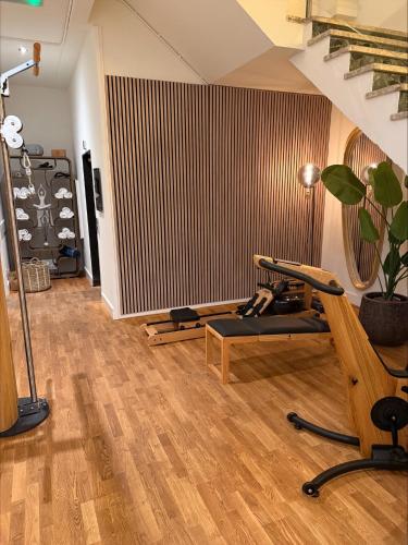 a room with a gym with a bench and a treadmill at Boutique Hotel Lumiere in Eindhoven