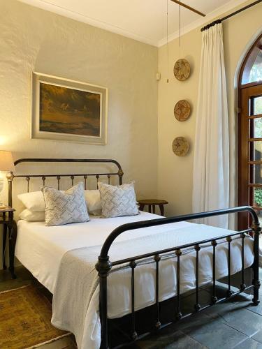 a bedroom with a bed with white blankets and pillows at Casa Miramare - Marina Beach in Southbroom