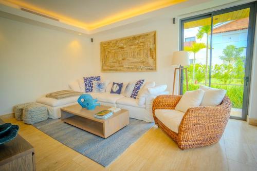 a living room with a couch and a table at Villa Libertad, amazing pool ,modern design in El Infiernito