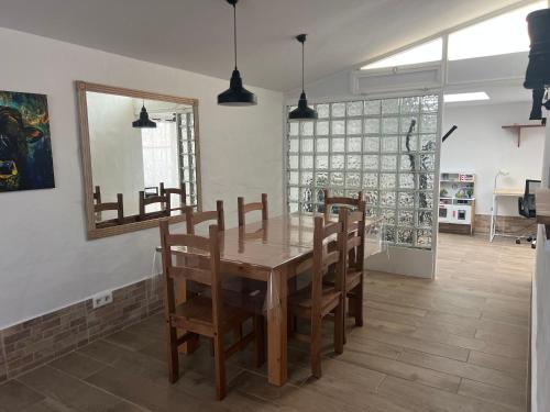a dining room with a wooden table and chairs at Casa Joy in La Oliva