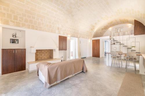 a large living room with a bed and a kitchen at Villa Verdena up in Carovigno
