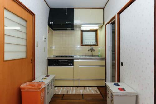 a kitchen with a stove and some boxes in it at 西新宿和庵 wa-an homestay in Tokyo