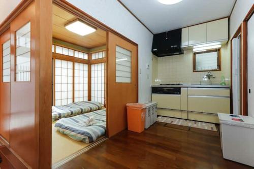 a kitchen with two beds in the middle of a room at 西新宿和庵 wa-an homestay in Tokyo