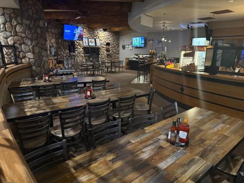 a restaurant with wooden tables and chairs and a bar at Grand Lodge in Crested Butte