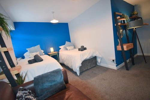 a living room with two beds and a couch at New The Hideaway at Calver Arms in Stoney Middleton