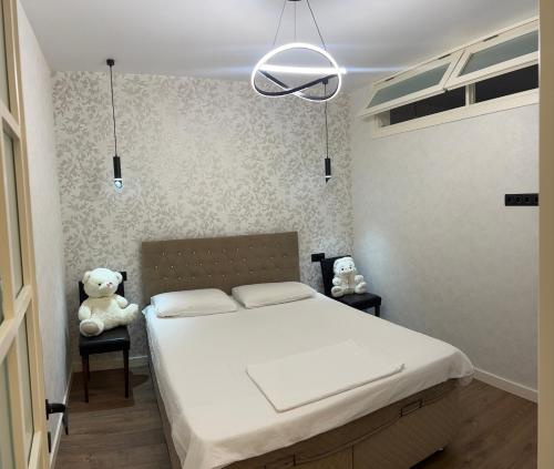 a bedroom with a white bed and a teddy bear at Sunny Escape in Gonio in Gonio